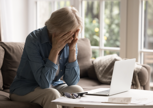 older woman with head in hands