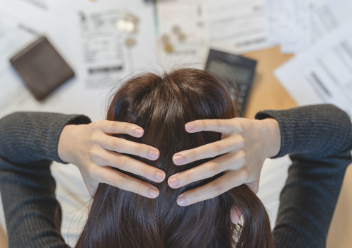stressed woman looking at finances