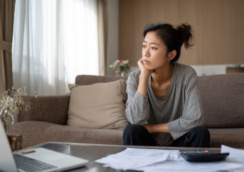 woman worried with paperwork and computer