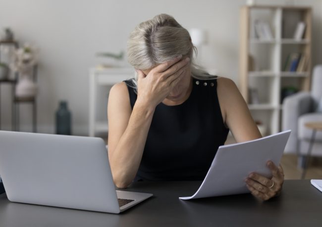 blogimage-082026 woman grieving with paperwork
